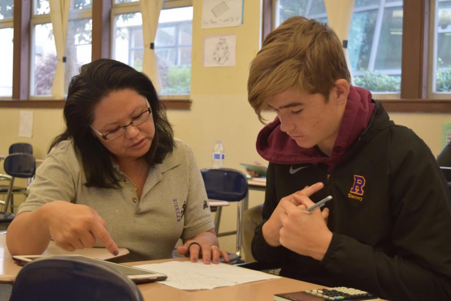 Math teacher Mary Ann Datoc helps Ian Slattery ’22 with his work.