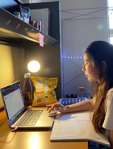 Boarding student Meidyn Nguyen ’21, from Vietnam, studies for one of her classes while in her dorm room on campus.