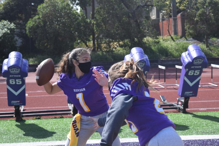 Elci Cortes ’22 and Delaney Mulqueen ’22 demonstrate what a girls flag football team might look like on Mayer Family Field in the near distant future 