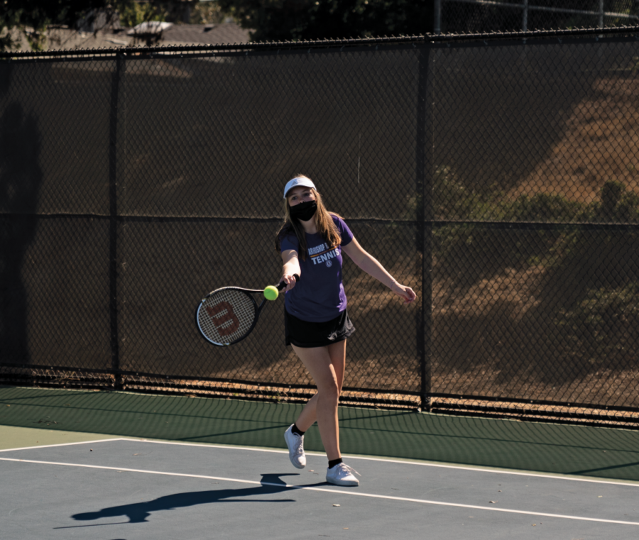 Deanie Cooper 24 takes a swing during a tennis match. 