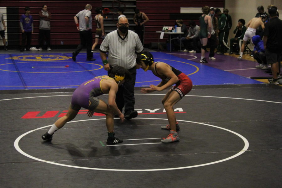 Logan Scudmore ’22 faces off against an opponent at a recent wrestling meet.