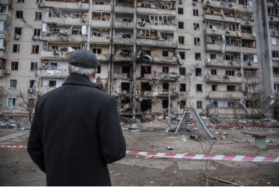 A Ukrainian man looks upon the destruction caused by a
Russian missile strike at an apartment complex in Kyiv.
