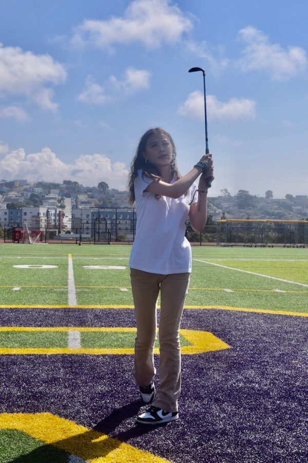 Girls golf captain Kyla Duong ‘25 practices her swing. 