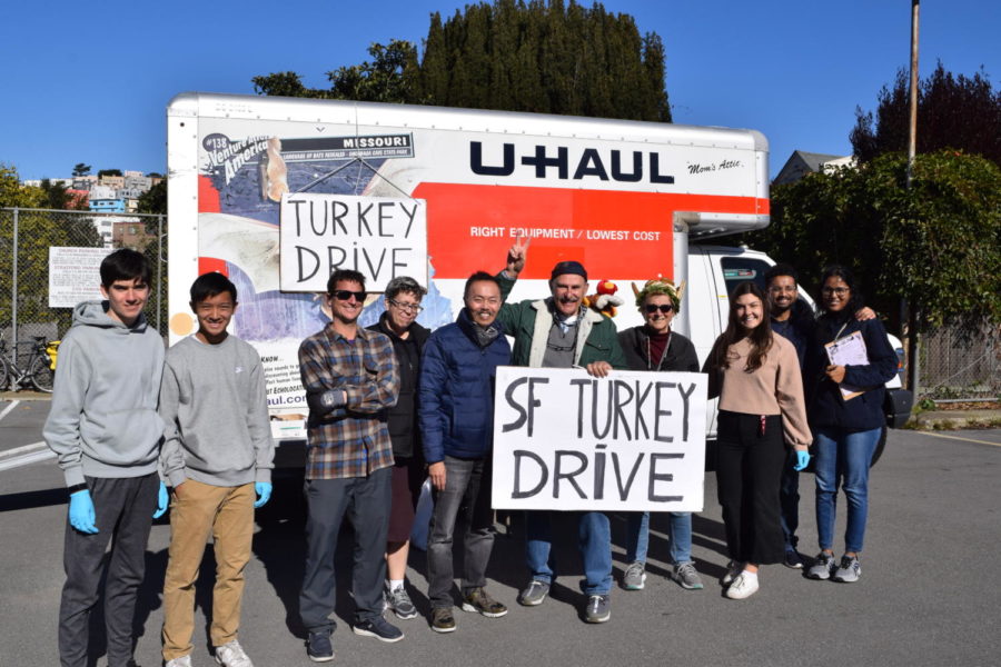 Volunteers pose in front of the Uhaul that brought turkeys to St. Anthonys.