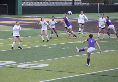 India Bowles ’23, midfielder, kicks the ball aiming for the goal as Samantha Rengifo ’24 runs to assist in the Senior Day game against College Prep.