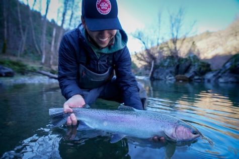 Cash Bolos ’23 displays a steelhead trout he caught in the Trinity River.