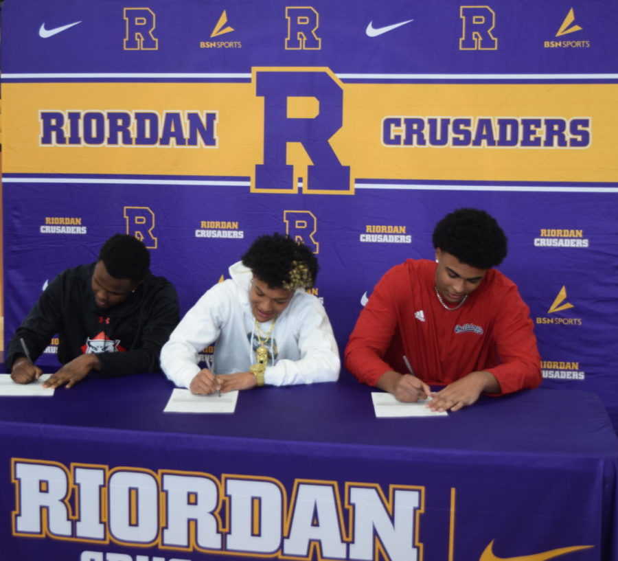 Zion Wells 23, Zachary Jones 23, and Isiah Chala 23 smile as they sign to their next schools: Davidson College, UC Davis, and Fresno State.