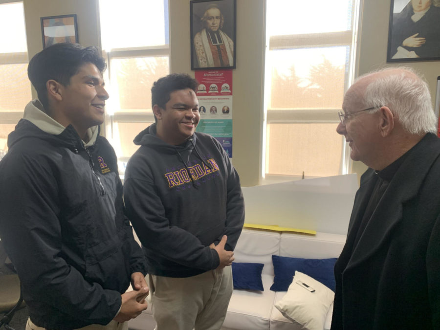 CORE Team members Jose Lopez ’23 and Juan Jackson ’23 discuss
the Ash Wednesday service with Riordan chaplain Fr. Greg Heidenblut.