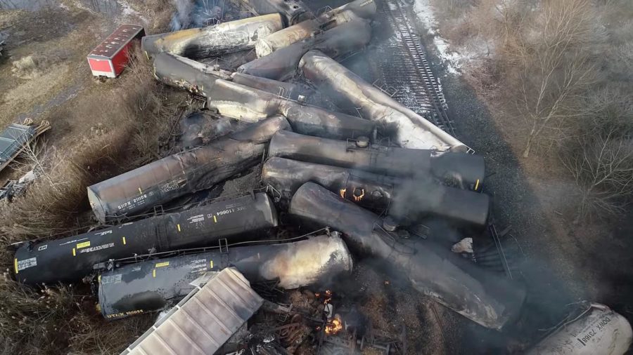 Toxic fumes spew from the derailed train, threatening the communities. 