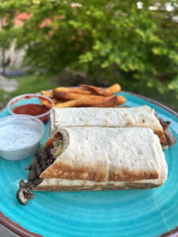 Red Eye Grill’s lamb and beef shawarma wrap, a combination of savory and spicy flavors, full of meats and fresh vegetables with fries on the side.