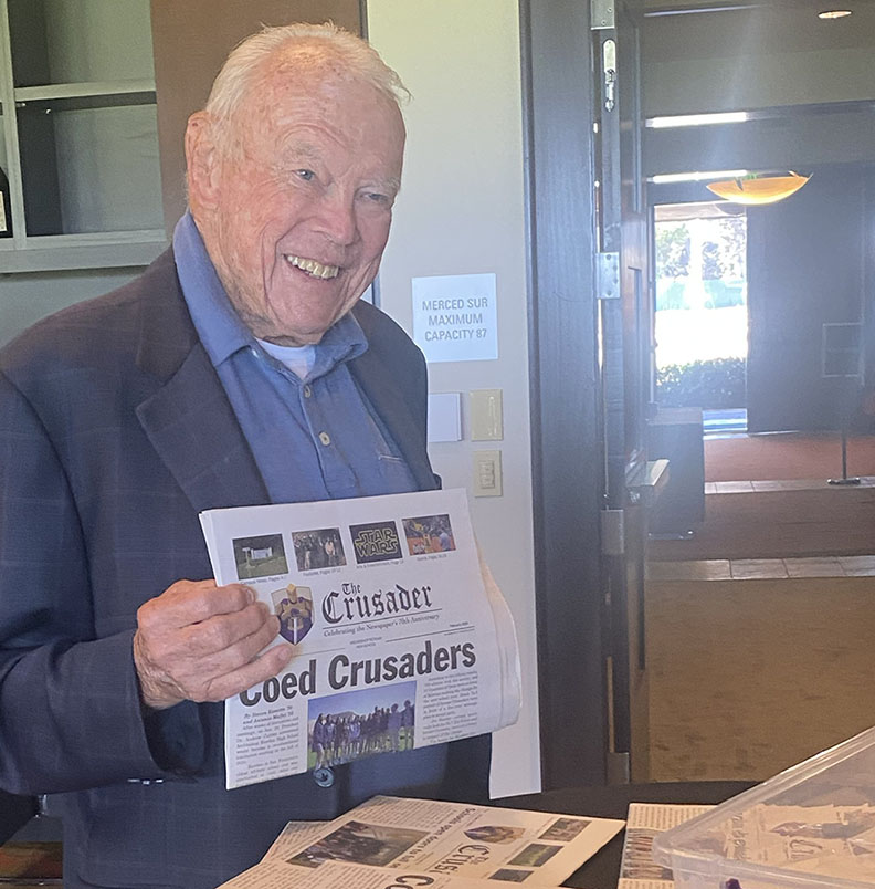 Bernard Cotter 50, the first editor-in-chief of Archbishop Riordans newspaper, holds a copy of The Crusader at the Golden Grad Luncheon on Aug. 31, 2022.