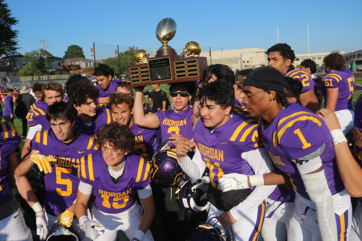 Crusaders celebrate winning the Haskell trophy from the Wildcats 