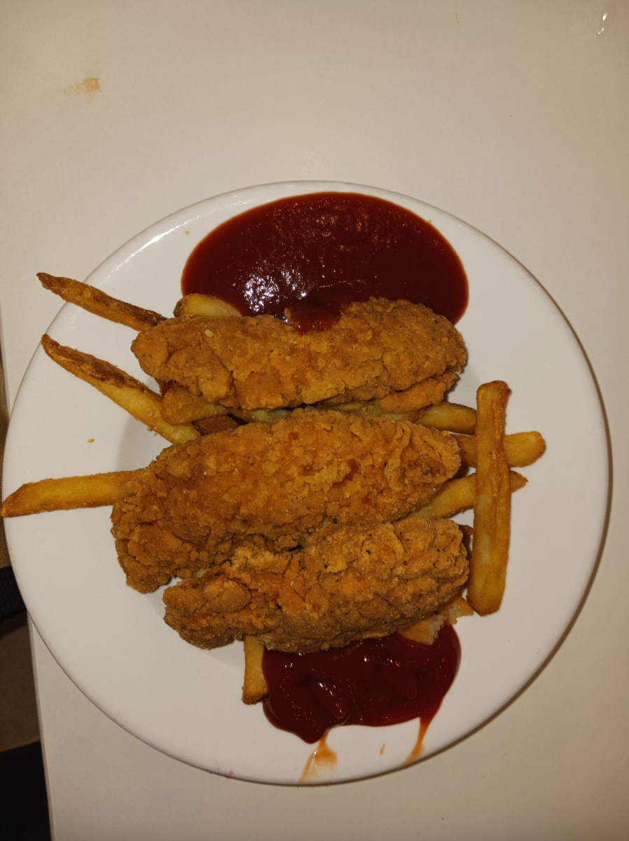 Chicken tenders and French fries flanked by BBQ sauce and ketchup.