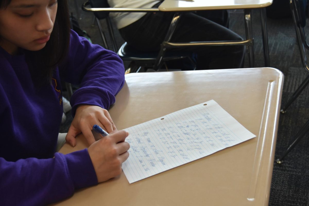 A student practices cursive penmanship, which will be added back into California curriculum in the near future with Gov. Gavin Newsoms Support