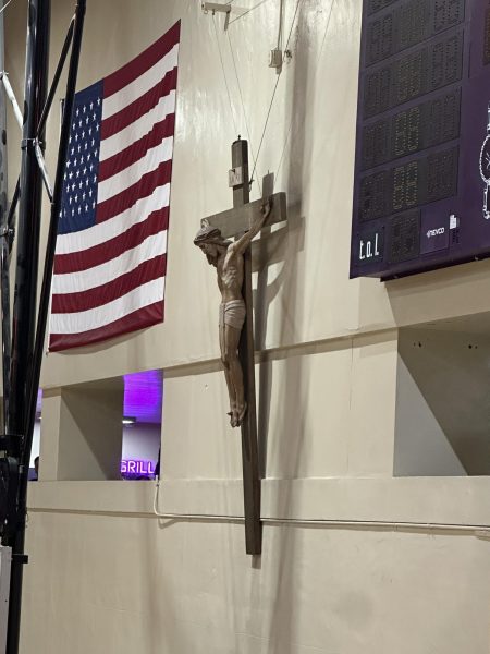 The 100-pound crucifix that was once in the stairwell near the library was moved to its new location in the gym in January.