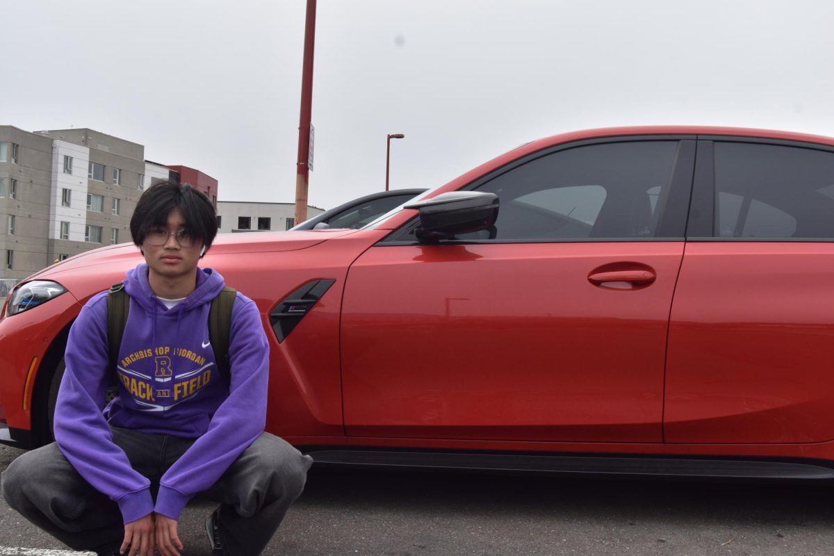 Jonathan Lee ’26 poses in front of a M3 Competition, which he was scoping out to take photos for his Instagram page.