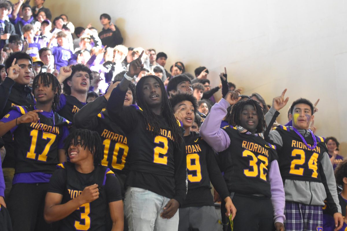 Members of the football team sing the alma mater at the homecoming rally,
which kicked off a weekend of festivities, culminating with the football game.