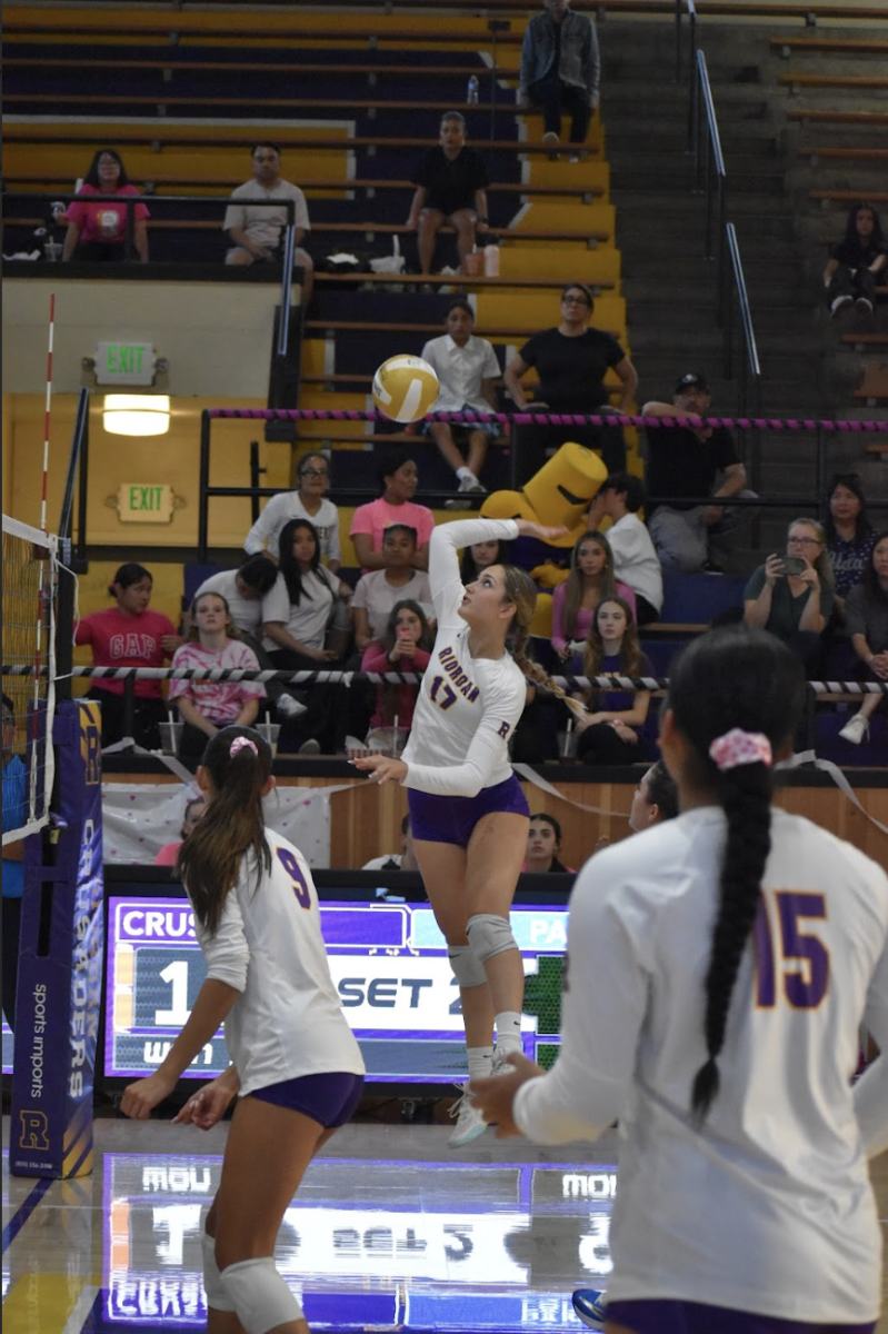 Mia Ikonomov '27 spikes the ball over the net in a recent home game. 