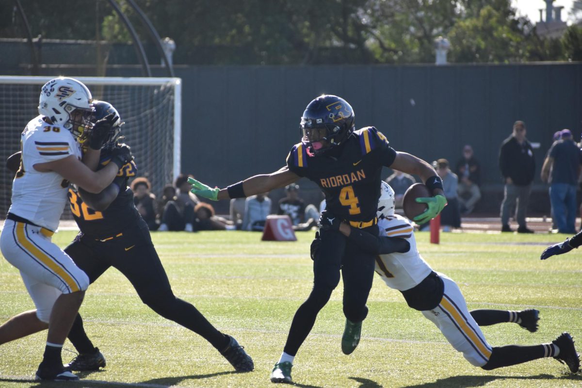 Chris Lawson ’25 runs the ball down field in a game versus Saint Francis.