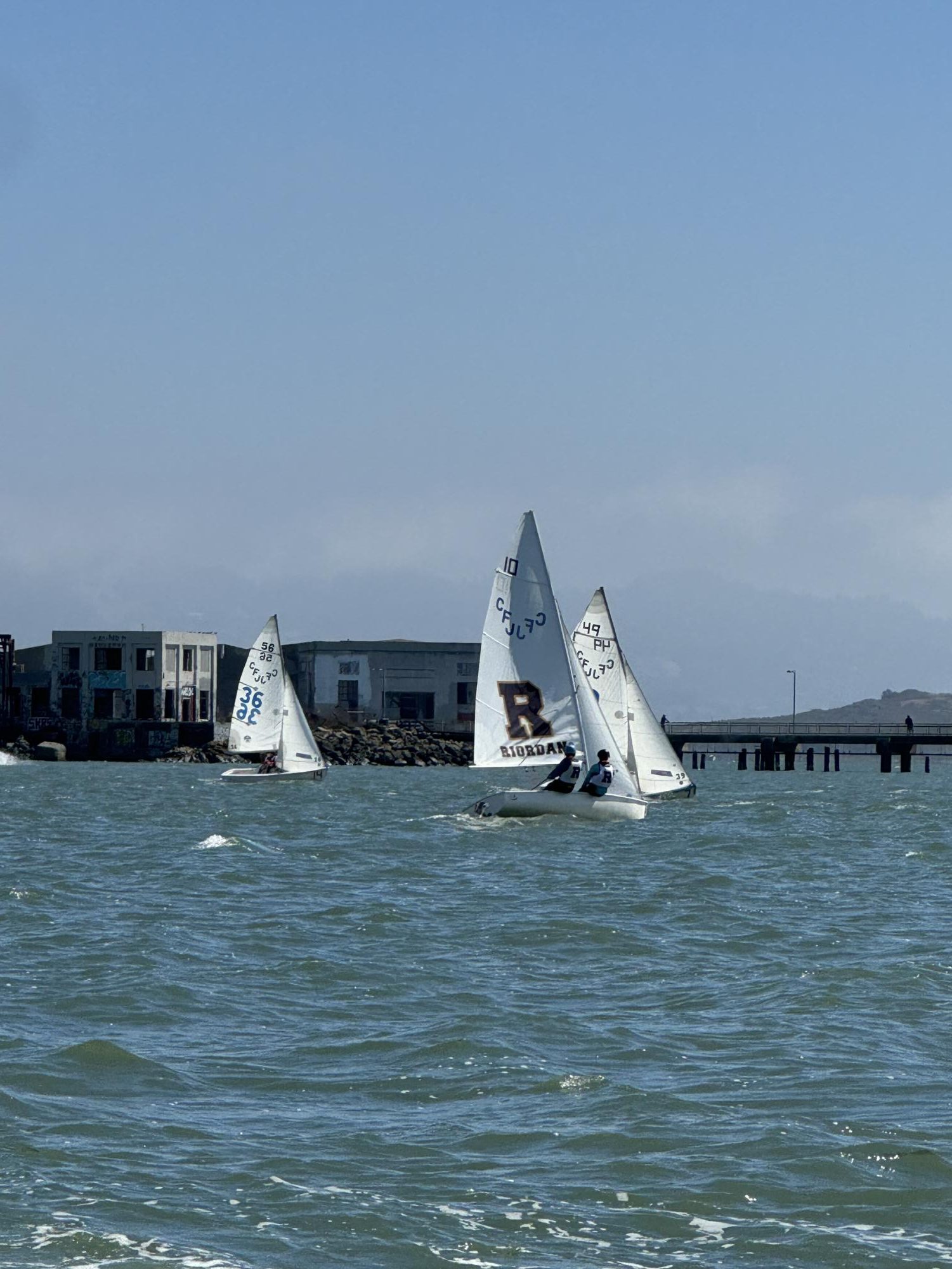 Eva Bennett ’25 and Paige Walsh ’27 battle the waves and competitors.