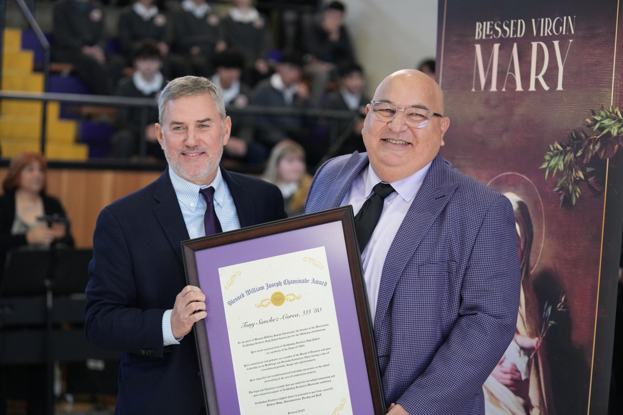 President Tim Reardon hands Tony Sanchez Corea III ’80 the Chaminade Award.