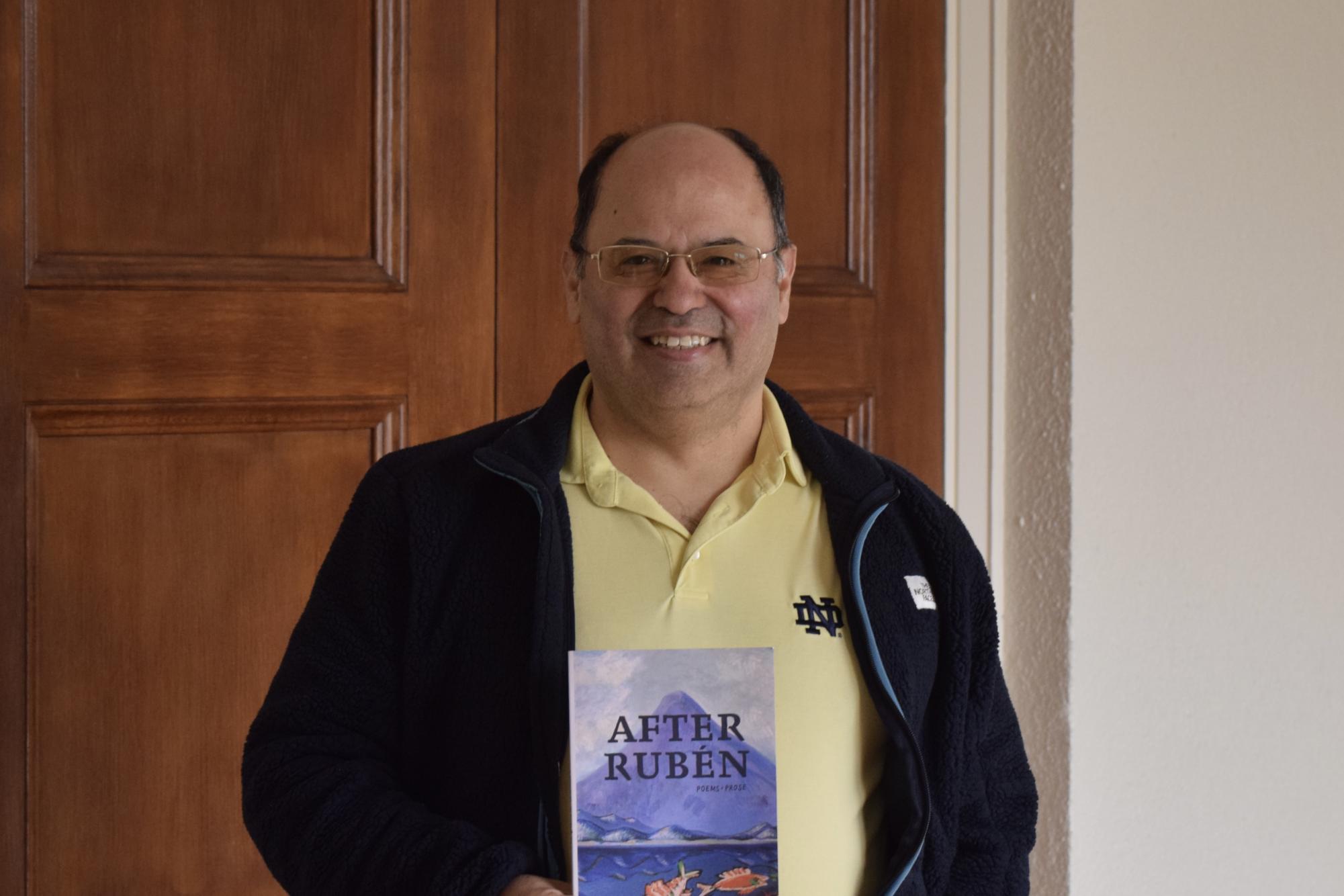 Francisco Aragón ’84 poses for a photo with his poetry book, “After Ruben.”