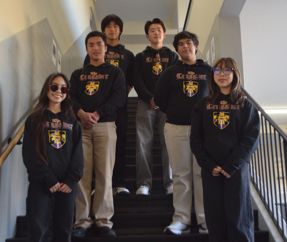 Students pose with the newspaper sweatshirts, displaying solidarity as this logo will no longer represent The Crusader after this December 2025 issue.