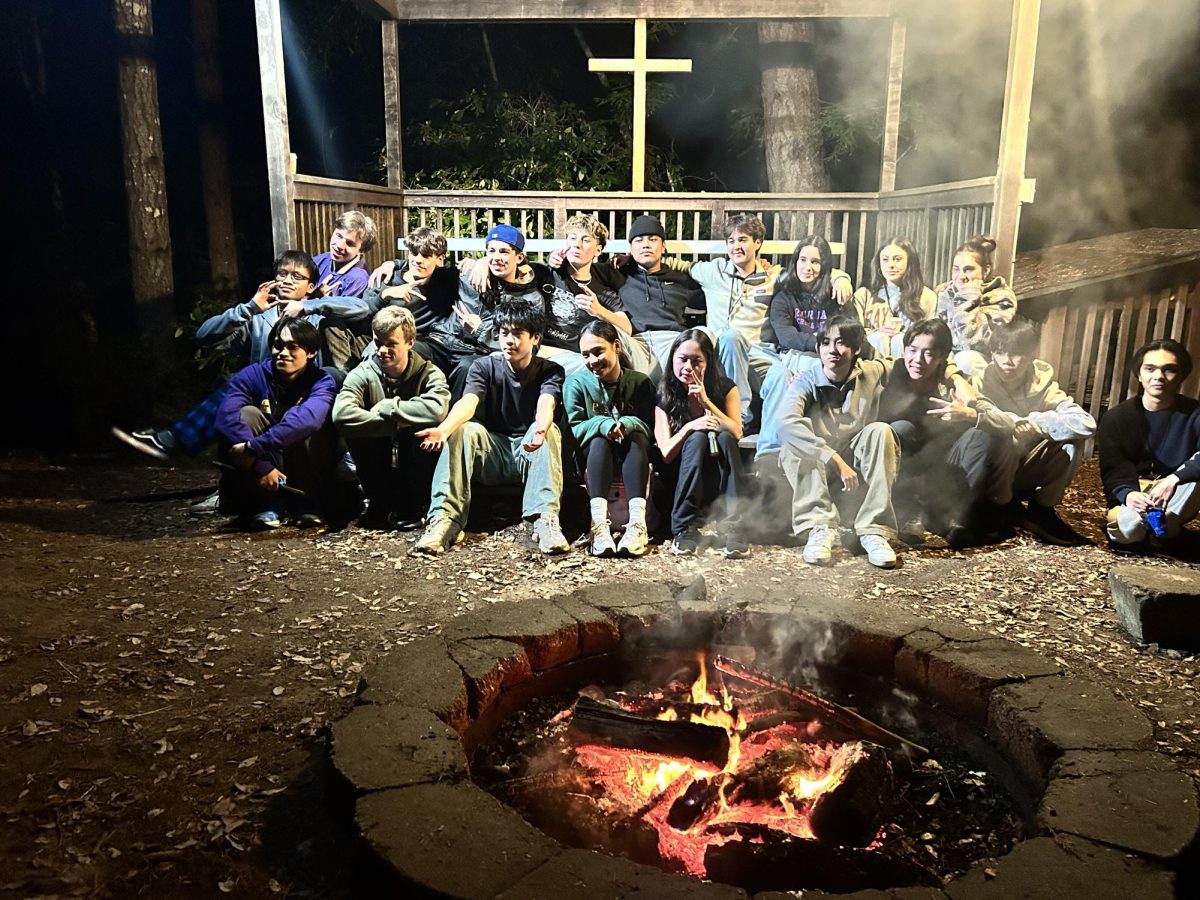 Emmaus retreat members enjoy each other’s company over a campfire.