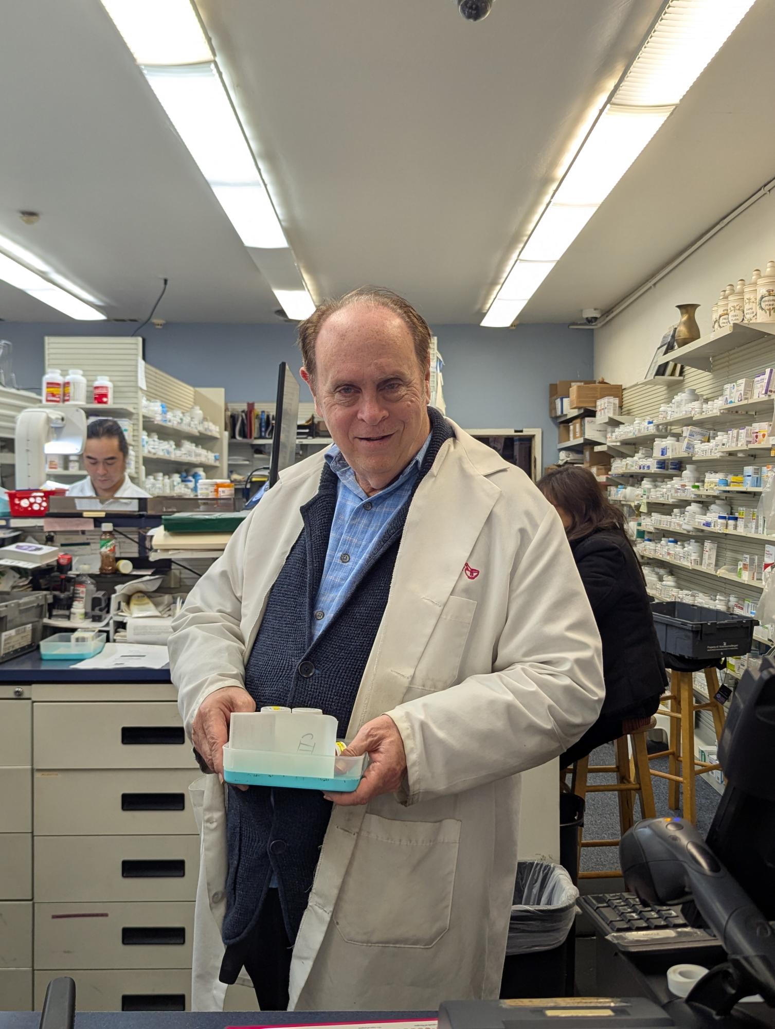 Steven Protzels, Pharm. D, stands confidently behind the counter of Daniel's Pharmacy, helping the Excelsior neighborhood with every prescription he fills. 