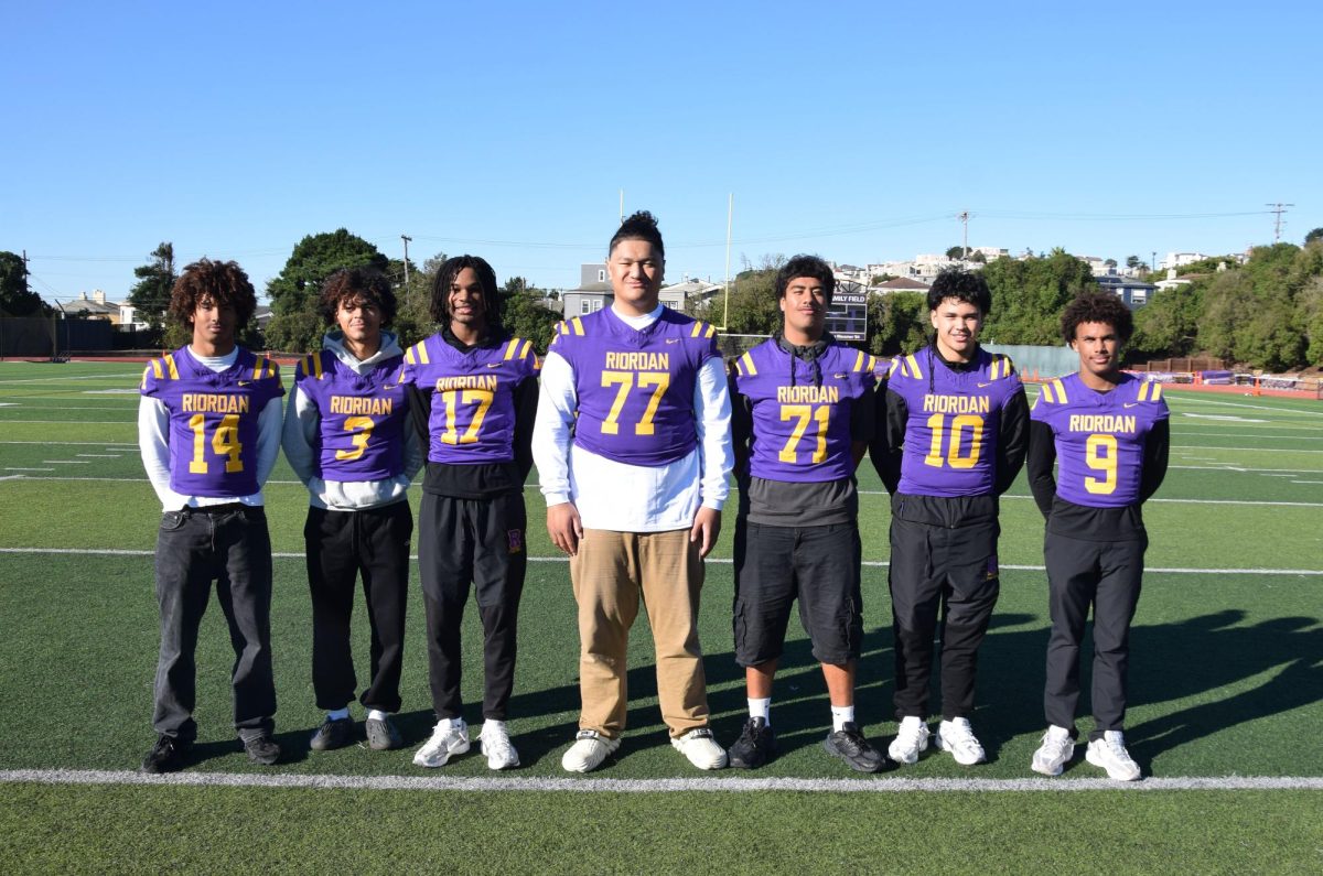 Judge Nash ’26, Perrion Williams ’26, Cynai Thomas ’26, Tommy Tofi ’26, Michael Langi ’26, Skylar Tiatia ’26, and Michael Mitchell ’26 stand on Mayer Family Field, the site of many victories this football season.