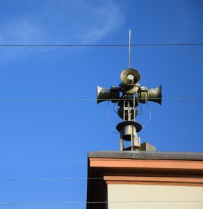 An inactive warning siren remains perched atop a building, a reminder that San Francisco’s warning system has been down since 2019.