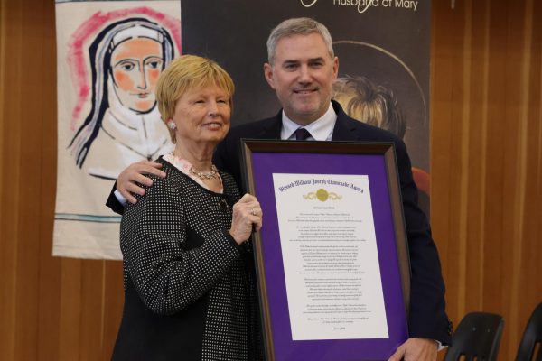 President Tim Reardon and Ottilie Valverde proudly pose for photos after she was presented with this year's Chaminade Award. 