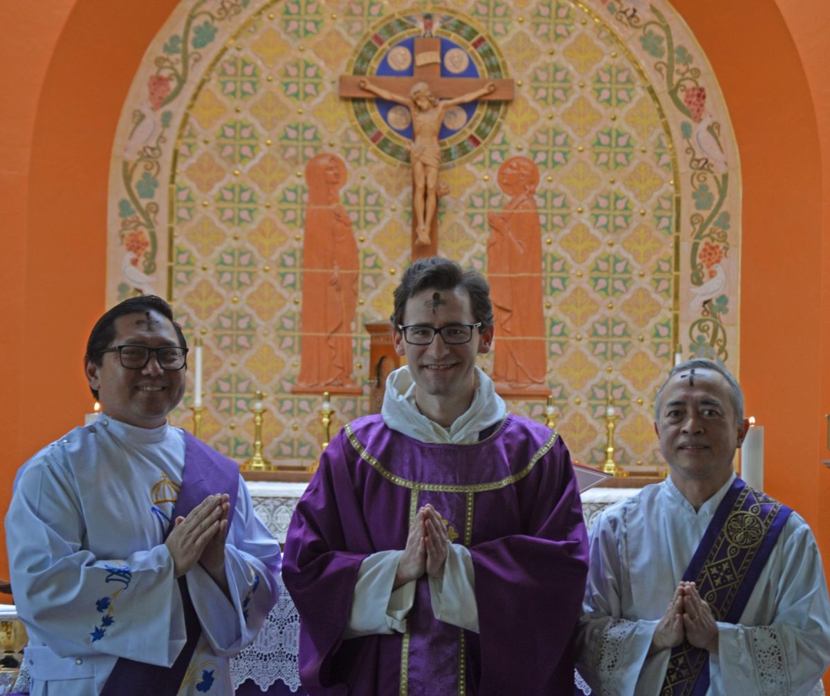 Deacon Chris Mariano, Father Patrick Rooney and Deacon Ivan Soegiharto stand in front of the altar on the ay of Ash Wednesday’s morning Mass.