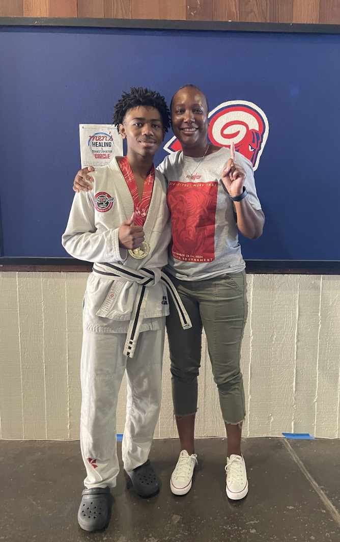 Derrill “DJ” Floyd ’27, dressed in his gi with his medal around his neck,
poses with his mother, Shonta Bryant, after winning the American Cup.