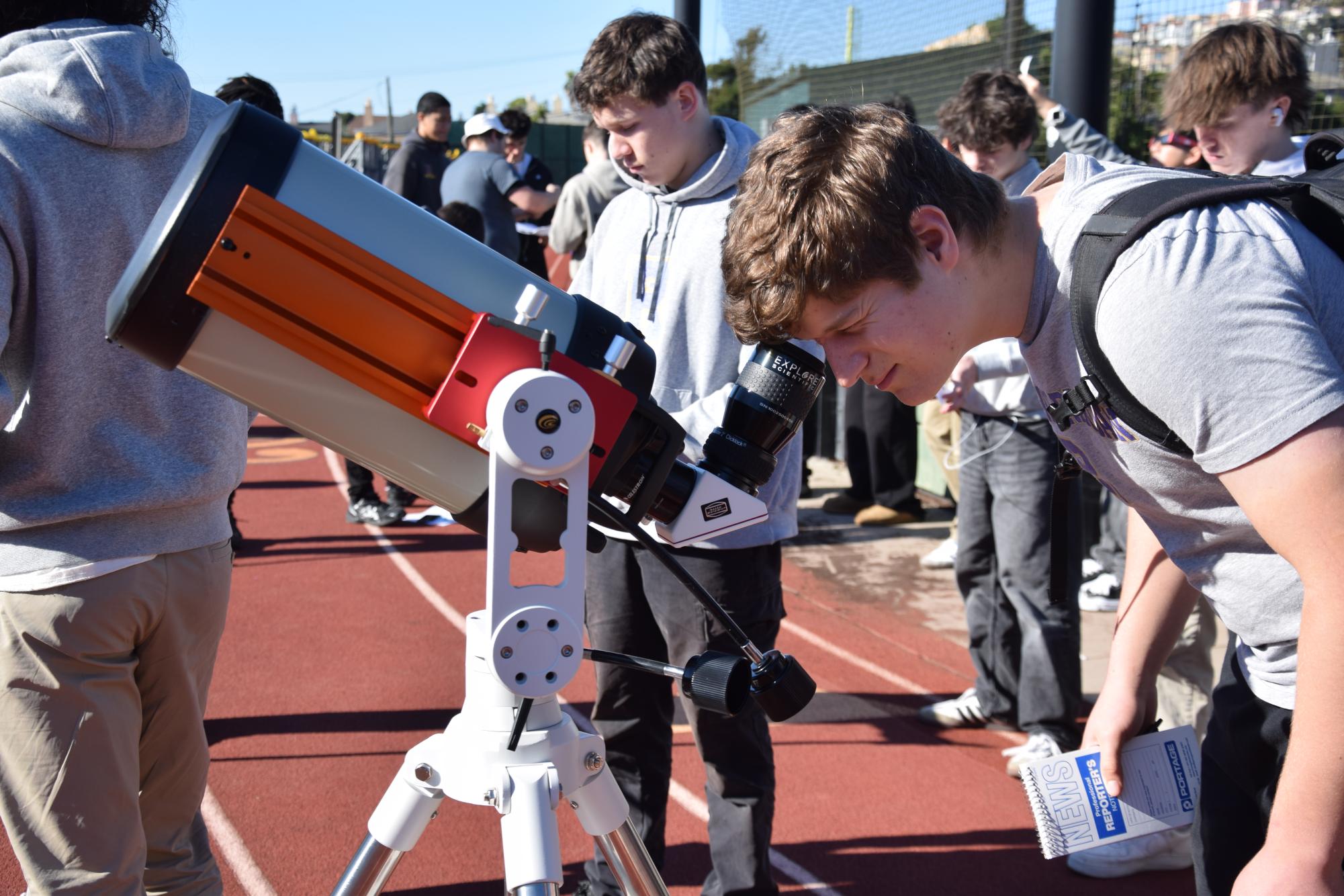 Nathan Molinari ’27 looks through a telescope to investigate solar flares.