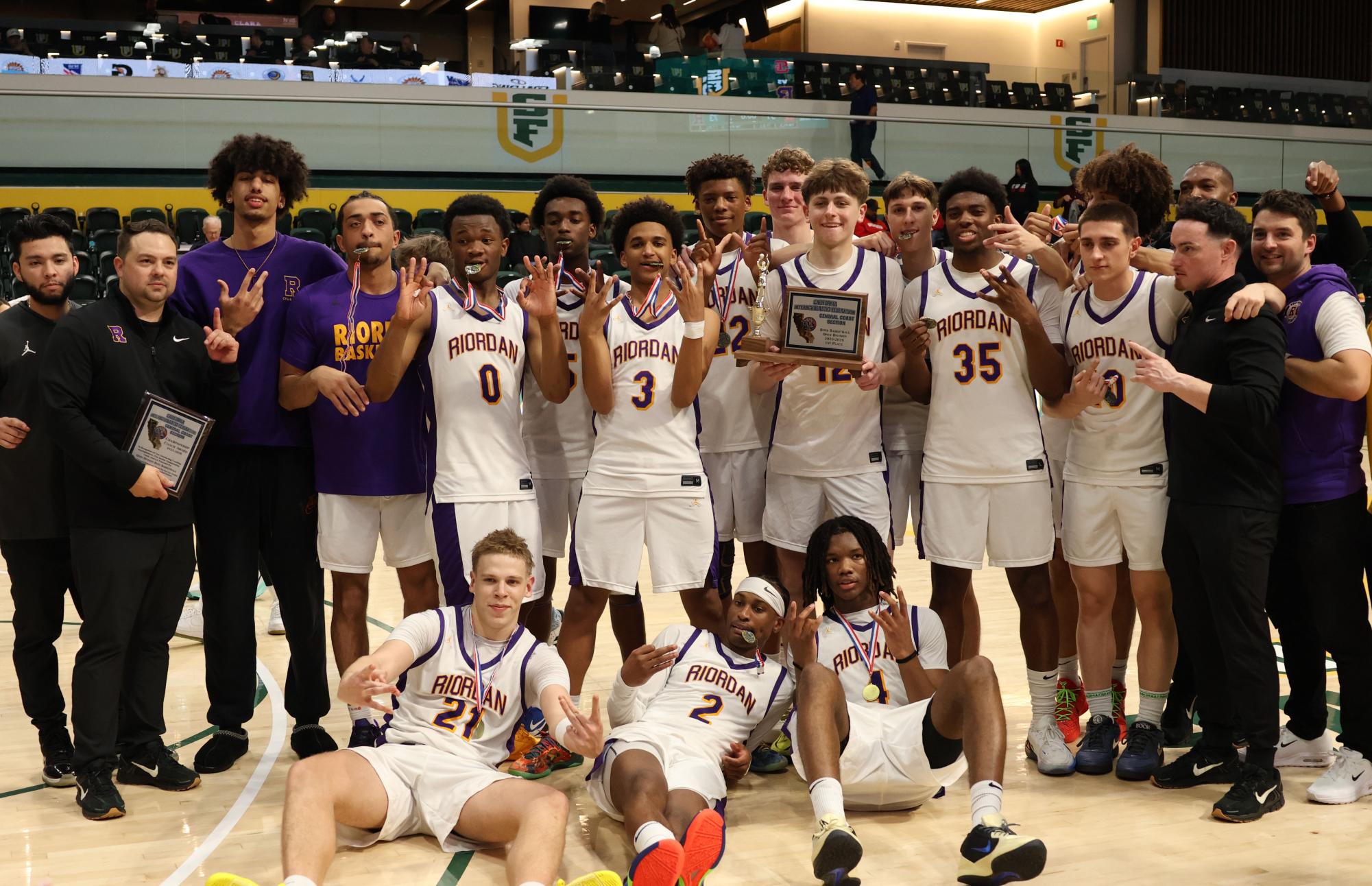 The team celebrates with coaches after CCS Championship win.