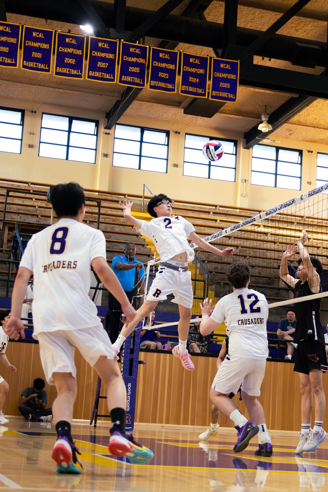 Brandon Yang ’27 leaps to spike a ball in a game against Lowell High School.