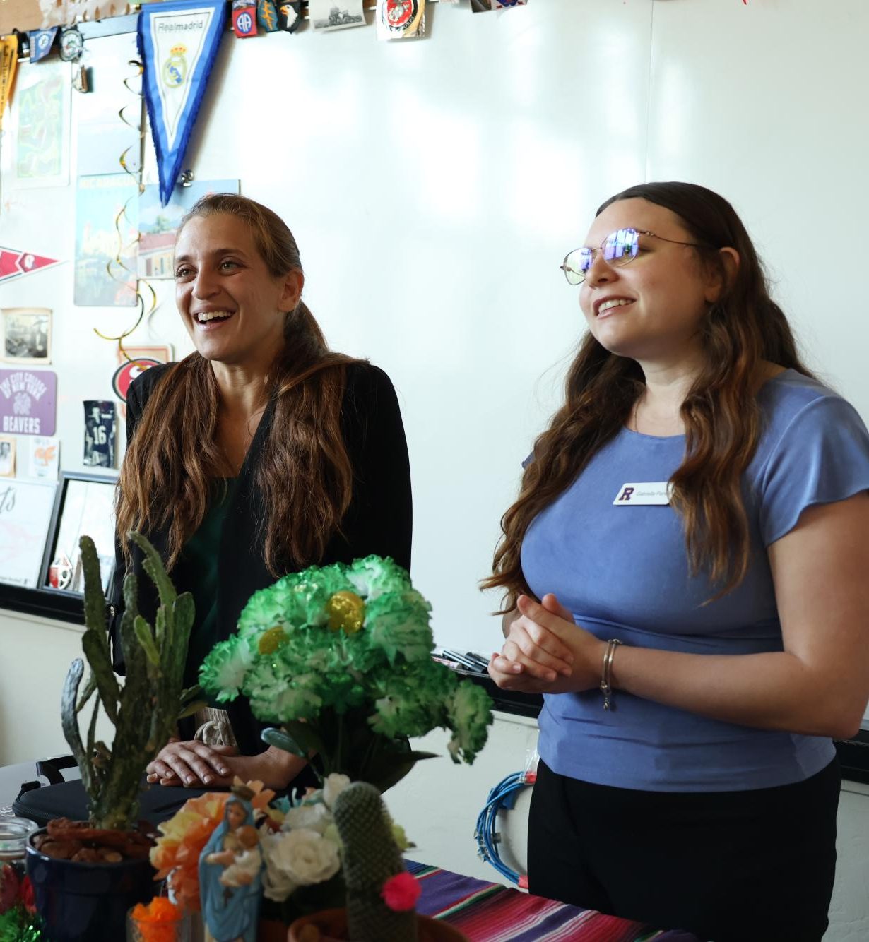 Language department teachers Avishan Peer and Gabriella Panelli talk to a prospective student at Archbishop Riordan's Accepted Students Night event.